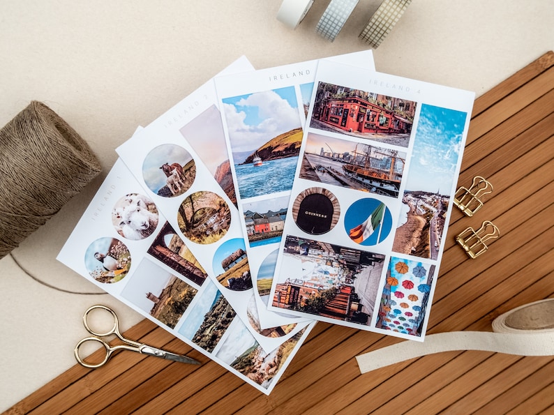 May include: A set of four sheets of stickers featuring images of Ireland. The stickers are printed on white paper and have a glossy finish. The images include a sheep, a lighthouse, a boat, a pub, a street scene, and a flag. The stickers are labeled "Ireland" and "Ireland 2".