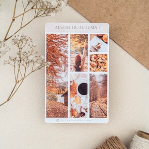 May include: A set of six autumn-themed stickers featuring images of fall foliage, a woman in a red hat, a cup of coffee, and a train track. The stickers are arranged in a grid pattern and have a white background. The text "AESTHETIC AUTUMN I" is printed at the top of the sheet. The text "STICKTOYOUSTORE" is printed at the bottom of the sheet.
