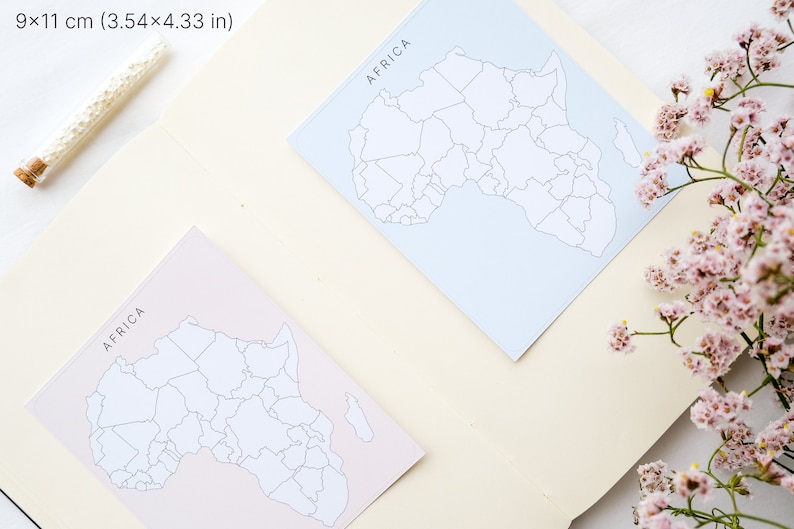 May include: Two square cards, each 3.54 x 4.33 inches, feature a map of Africa with the word "AFRICA" at the top. One card is light blue, the other is light pink. A small glass vial and pink flowers are also in the image.