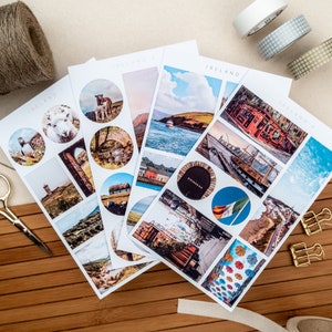 May include: Four sheets of stickers featuring images of Ireland. The stickers are round and rectangular and feature images of sheep, a lighthouse, a thatched roof cottage, a harbor, a city street, and a pub. The stickers are on a white background.