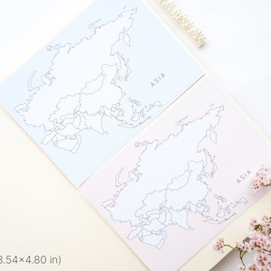 May include: Two cards with a map of Asia, one light blue and one pink, are displayed open in a notebook. The word "ASIA" is printed on each card. The cards measure 3.54 x 4.80 inches. Pink flowers are in the corner.