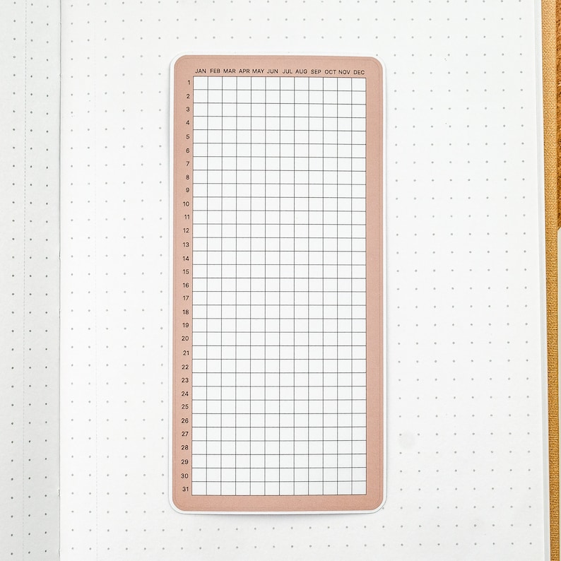 May include: A printable calendar sticker with a grid layout for each month of the year. The sticker is peach colored with black text and lines. The months are labeled: January, February, March, April, May, June, July, August, September, October, November, December. The days of the month are numbered 1 through 31.