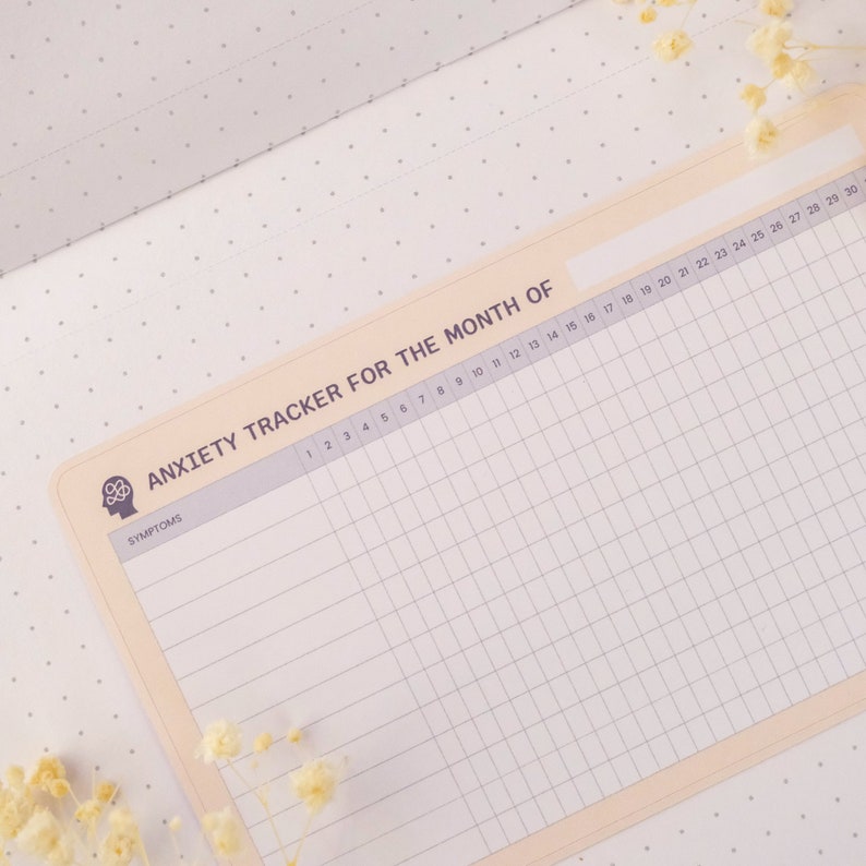 May include: A printable anxiety tracker for the month, featuring a brain icon and the word "Symptoms" at the top. The tracker has a grid with numbered days of the month and rows for tracking symptoms.