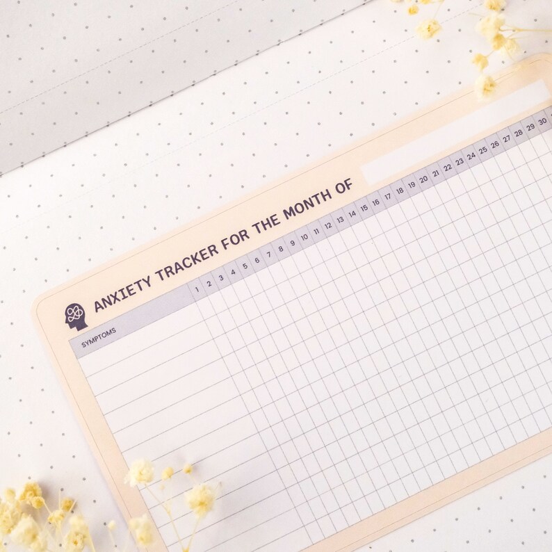 May include: A beige printable anxiety tracker for the month with a grid layout and the text "ANXIETY TRACKER FOR THE MONTH OF" at the top. The tracker has a column for symptoms and 30 columns for each day of the month.