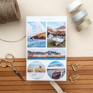 May include: A set of four stickers featuring scenic views of Ireland. The stickers are printed on white paper and have a glossy finish. The images include a boat in a harbor, a row of colorful houses, a lighthouse on a rocky island, and a sunset over the water.