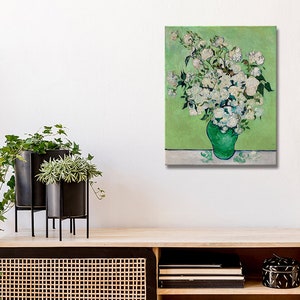 May include: A painting of a bouquet of white roses in a green vase against a green background.