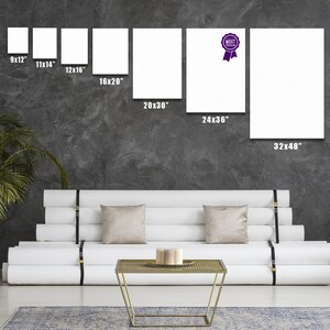 May include: A white couch with three cushions and a gold metal coffee table in front of it. The wall behind the couch has a variety of white canvases with different dimensions, including 9x12 inches, 11x14 inches, 12x16 inches, 16x20 inches, 20x30 inches, 24x36 inches, and 32x48 inches. One of the canvases has a purple ribbon with the text "MOST POPULAR" on it.