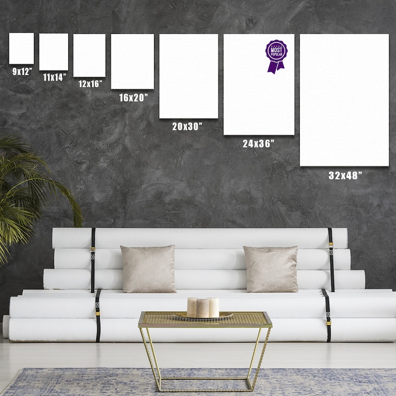 May include: A white couch with three cushions and a gold metal coffee table in front of it. The wall behind the couch has a variety of white canvases with different dimensions, including 9x12 inches, 11x14 inches, 12x16 inches, 16x20 inches, 20x30 inches, 24x36 inches, and 32x48 inches. One of the canvases has a purple ribbon with the text "MOST POPULAR" on it.