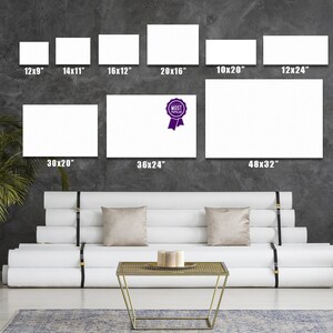 May include: A white couch with a gold metal coffee table in front of it. The wall behind the couch has a display of different sized white canvases with dimensions listed in inches. The canvas labeled "MOST POPULAR" is 36 inches by 24 inches.
