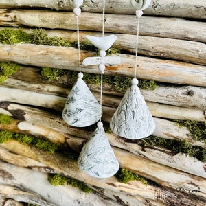 Handmade ceramic garden decoration.Composition of 3 floral pressed bells with driftwood.White clay .Handmade.Wind Chimes.Fine craft.