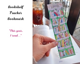 May include: A green bookmark with a bookshelf design. Each month of the year is represented by a shelf with colorful books. The bookmark has the text "2022!!!" at the top and "STORY" at the bottom.