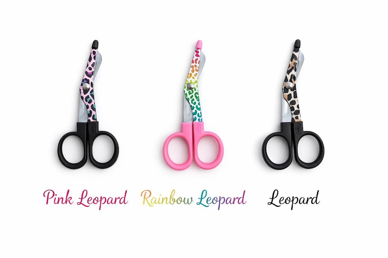 May include: Three medical shears with black handles and blades. The shears have colorful leopard print designs on the handles. The text below the shears reads "Pink Leopard", "Rainbow Leopard", and "Leopard".