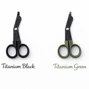 May include: Two medical shears, one black and one olive green, are displayed on a white background. The black shears are labeled "Titanium Black," and the green shears are labeled "Titanium Green." The shears have a unique angled design.