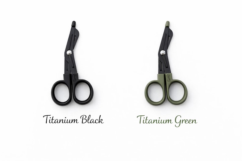 May include: Two medical shears, one black and one olive green, are displayed on a white background. The black shears are labeled "Titanium Black," and the green shears are labeled "Titanium Green." The shears have a unique angled design.