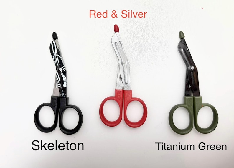 May include: Three medical shears in different colors: black with a skeleton design, red, and titanium green. The text "Red & Silver", "Skeleton", and "Titanium Green" are displayed.