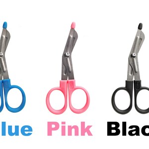 May include: Three medical shears in blue, pink, and black. Each shear has a silver blade and a colored handle. The text "Blue", "Pink", and "Black" is below each shear.