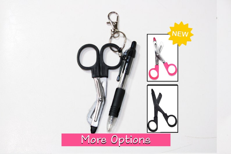 May include: A black medical shears with a silver blade, a black pen, and a silver keychain. The image also shows a pink banner with the words "More Options" and two additional images of shears, one pink and one black.