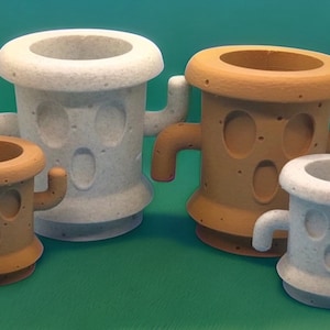 May include: Four small, white and brown ceramic planters shaped like cacti with cartoon faces. The planters have a textured surface and are perfect for small plants.