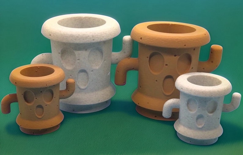 May include: Four small, white and brown ceramic planters shaped like cacti with cartoon faces. The planters have a textured surface and are perfect for small plants.