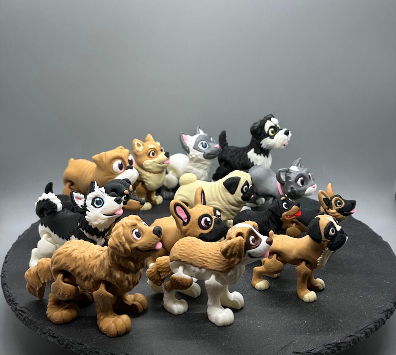 May include: A collection of 13 small, hand-painted figurines of dogs in various breeds and poses. The figurines are made of a light brown, gray, and black material and have realistic details.