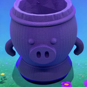 May include: A purple, pig-shaped planter with a round body, two small arms, and a snout with two nostrils. The planter has a wide opening at the top and sits on a grassy surface with flowers.