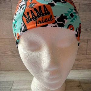 May include: A turquoise, orange, and black headband with a cow print and the text "Mama Tried".