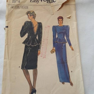 May include: A vintage sewing pattern for a dress with two different styles. The pattern is for size 8 and is from Very Easy Vogue. The pattern shows a black dress with a peplum and a blue dress with a slit.