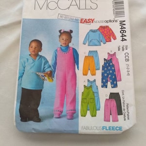May include: McCall's sewing pattern for children's clothing, pattern number M4644, size CCB (1-2-3-4), featuring a variety of fleece pants and tops in pink, blue, green, and yellow.