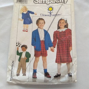 May include: Simplicity sewing pattern number 9382 for children's clothing. The pattern includes instructions for making a dress, a cardigan, and shorts. The pattern is designed by Florence Eisman.