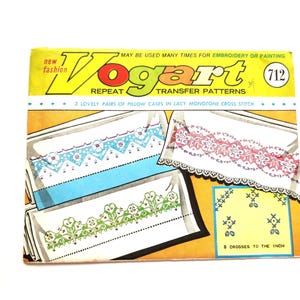 May include: A vintage Vogart repeat transfer pattern envelope, number 712, featuring illustrations of lacy monotone cross stitch designs for pillowcases in blue, pink, and green. The yellow and white packaging includes text instructions.