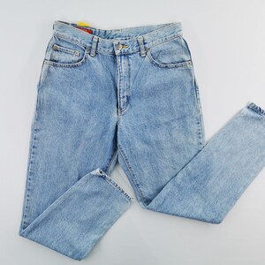 May include: Light blue denim jeans with a classic five-pocket design. The jeans have a button and zipper closure, belt loops, and a straight leg cut. The denim appears to be a medium weight, suitable for everyday wear.