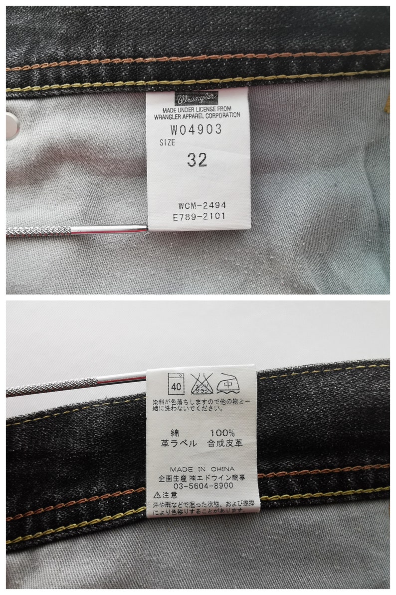 May include: Close-up of the inside of a pair of black denim jeans. A white tag displays "Wrangler" and size "32". Additional tags provide care instructions and material composition. The jeans have yellow and brown stitching.