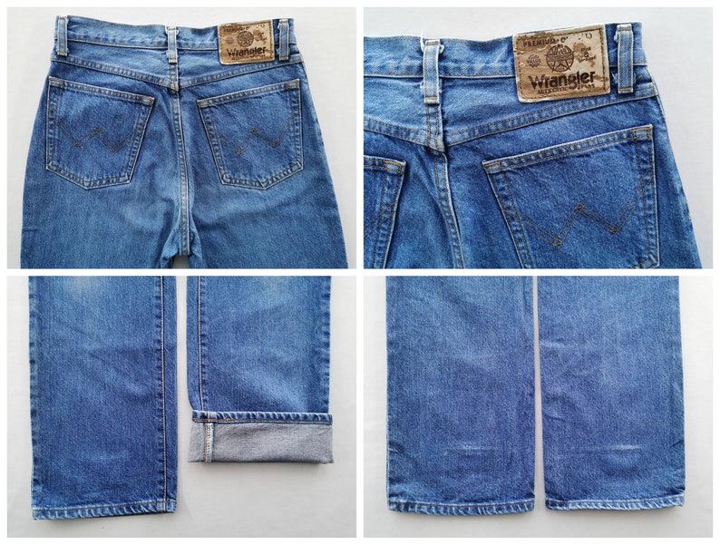 May include: Blue denim Wrangler jeans. The jeans have a classic five-pocket design, with the Wrangler logo patch on the back. The jeans are a medium wash and have a straight leg fit. The jeans are cuffed at the bottom in one of the images.