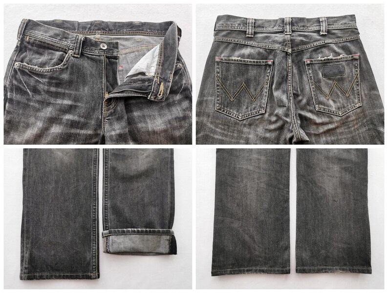 May include: Close-up shots of a pair of black denim jeans. The jeans have a button and zipper closure, front and back pockets, and the Wrangler logo on the back pockets. The jeans are distressed with faded areas.