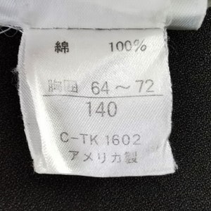 May include: A white fabric tag with Japanese characters, the number 100%, and the measurements 64-72 and 140. The tag also includes the text "C-TK 1602" and "Made in America."