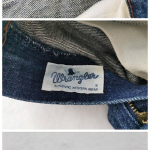 Peut inclure: Gros plan sur un jean en denim avec plusieurs &eacute;tiquettes. Une &eacute;tiquette indique les mesures : taille 78cm, hanches 96cm. Une autre &eacute;tiquette indique "Wrangler AUTHENTIC WESTERN WEAR". D'autres &eacute;tiquettes fournissent des instructions d'entretien.