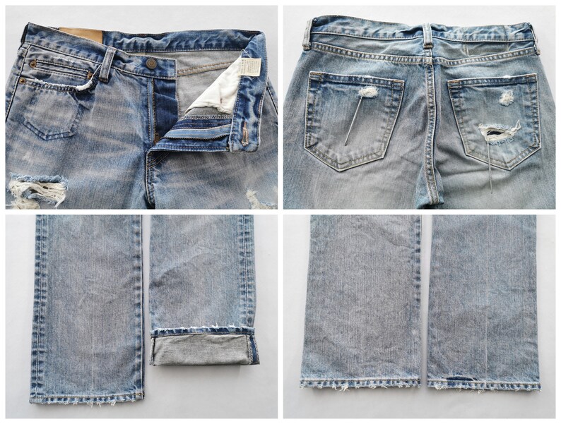 May include: Light blue denim jeans with distressed details, including rips and fading. The jeans have a button fly, classic five-pocket design, and a slightly worn appearance. The bottom of the jeans are cuffed.