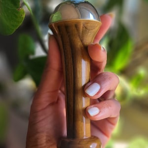 May include: A set of three ceramic mugs with a speckled, matte finish. The mugs are in shades of cream, light gray, and dark gray. Each mug has a simple, minimalist design, perfect for coffee or tea. The mugs are stacked on top of each other.