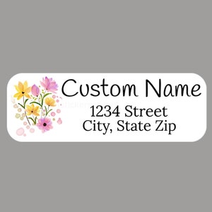May include: White label with a floral design in pink, yellow, and green. The text "Custom Name" is above the address "1234 Street City, State Zip".