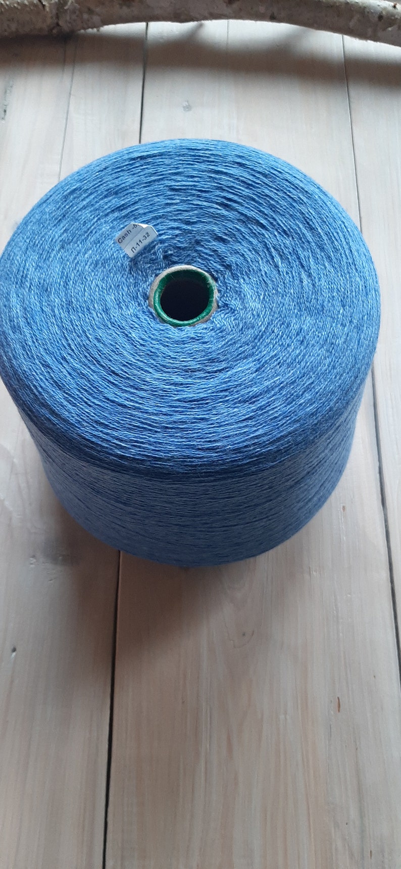 May include: A blue ball of yarn with a white label that says "Cash 4 L-11-32"