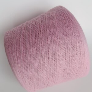 May include: A skein of pale pink yarn, wound into a ball shape.