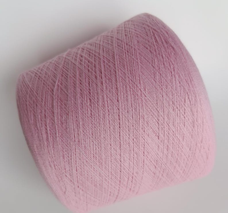 May include: A skein of pale pink yarn, wound into a ball shape.