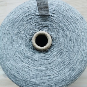 May include: A skein of grey yarn with a white label that reads "Cash 148" and "Г-33".