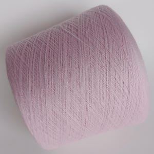 May include: A skein of pale pink yarn, wound into a ball shape.