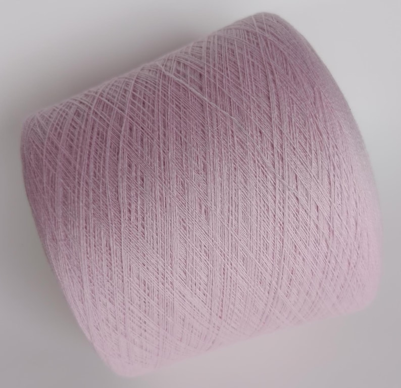 May include: A skein of pale pink yarn, wound into a ball shape.