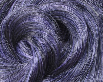 May include: Close-up of a bundle of dark purple hair extensions. The hair is smooth and shiny, with a slight sheen.