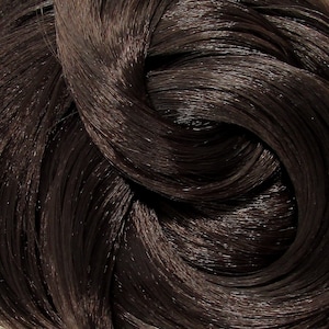 May include: Close-up of a dark brown hair extension. The hair is long and straight, with a smooth, shiny finish.