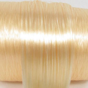 A pale blonde nylon doll hair for rerooting dolls, monster high reroots, standard 11.5 inch fashion dolls, custom rehairing and restoring all doll and toy types.