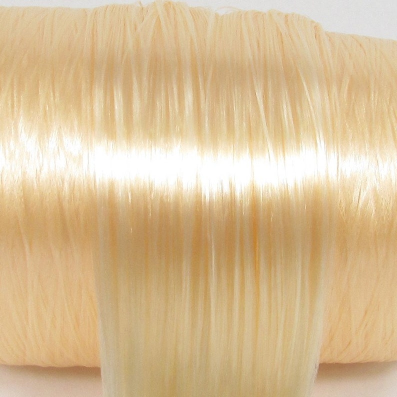 A pale blonde nylon doll hair for rerooting dolls, monster high reroots, standard 11.5 inch fashion dolls, custom rehairing and restoring all doll and toy types.