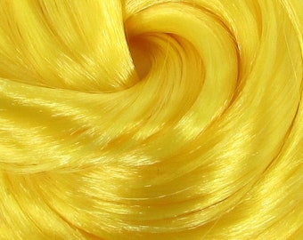 May include: Close-up of bright yellow yarn, showing the texture and shine of the fibers.